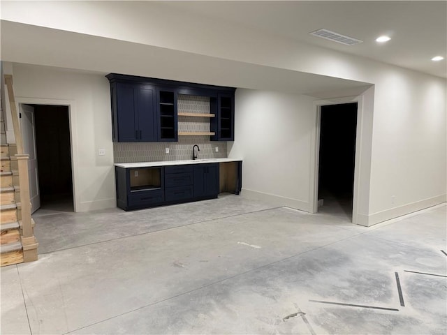 9301 SW Leviathan Ct, Lees Summit, MO 64064 - indoor wet bar with concrete flooring, tasteful backsplash, recessed lighting, and baseboards