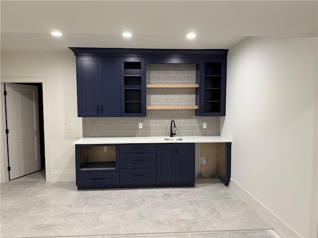 9301 SW Leviathan Ct, Lees Summit, MO 64064 - bar area featuring a sink, baseboards, tasteful backsplash, and recessed lighting