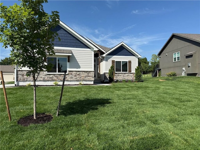9301 SW Leviathan Ct, Lees Summit, MO 64064 - rear view of house featuring stone siding and a yard