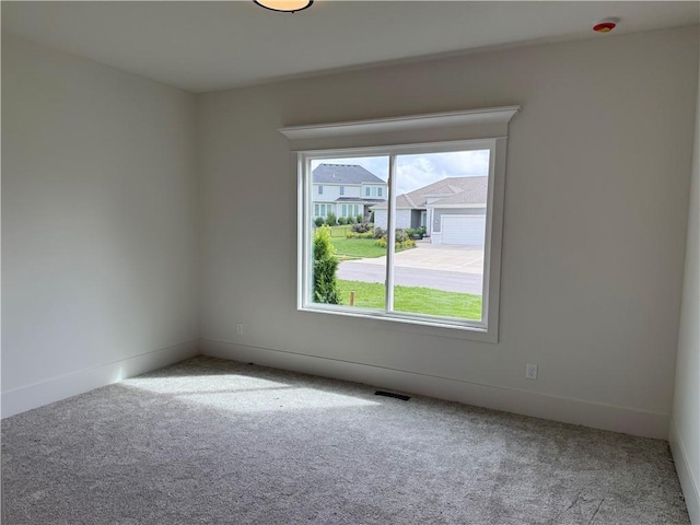 9301 SW Leviathan Ct, Lees Summit, MO 64064 - spare room featuring carpet and baseboards