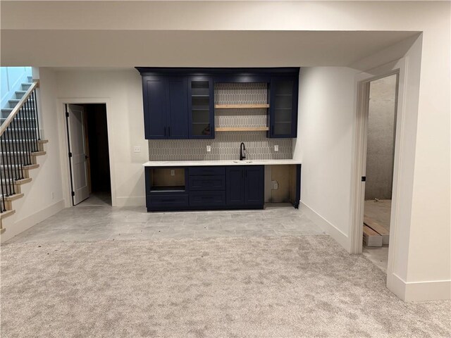 9301 SW Leviathan Ct, Lees Summit, MO 64064 - indoor wet bar featuring stairway, backsplash, and light colored carpet