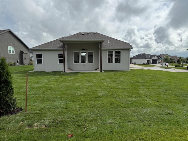 9301 SW Leviathan Ct, Lees Summit, MO 64064 - back of property with a ceiling fan, a lawn, a patio area, and a shingled roof