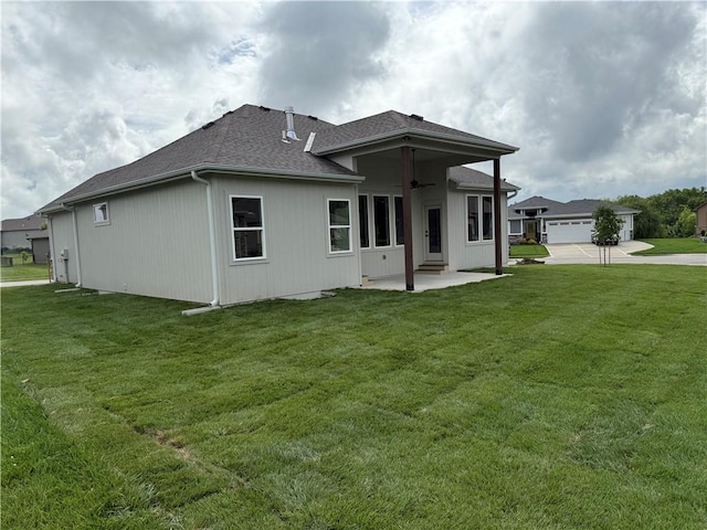 9301 SW Leviathan Ct, Lees Summit, MO 64064 - rear view of property featuring a patio area, a lawn, a ceiling fan, and roof with shingles