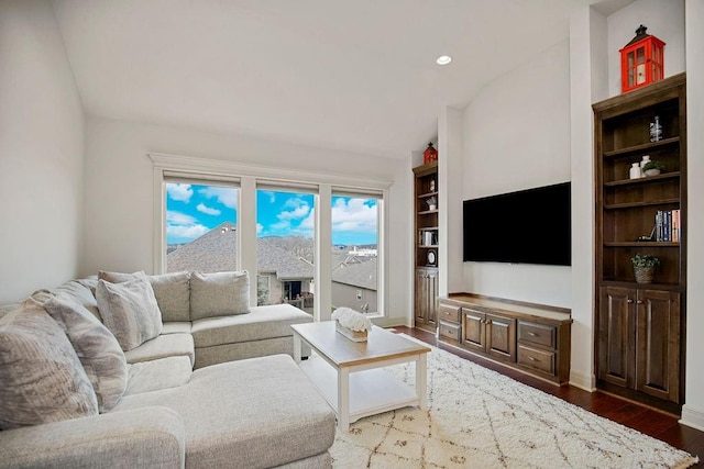 living room with hardwood / wood-style floors and vaulted ceiling