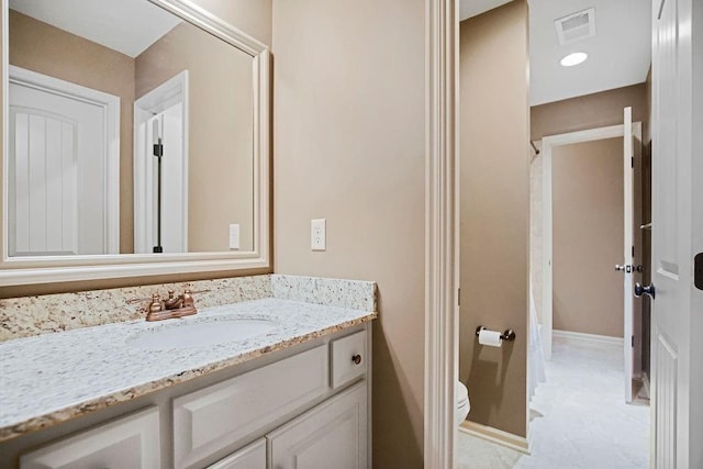 bathroom featuring vanity and toilet