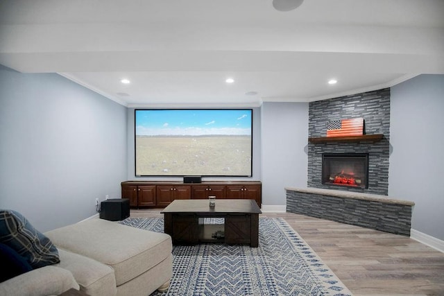 interior space with light wood-type flooring, a fireplace, and ornamental molding