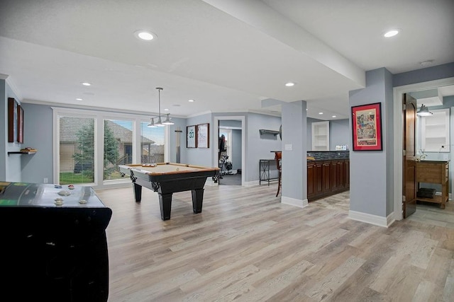 game room featuring light hardwood / wood-style floors, ornamental molding, and billiards