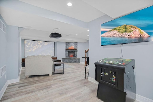 interior space featuring light hardwood / wood-style floors and a stone fireplace