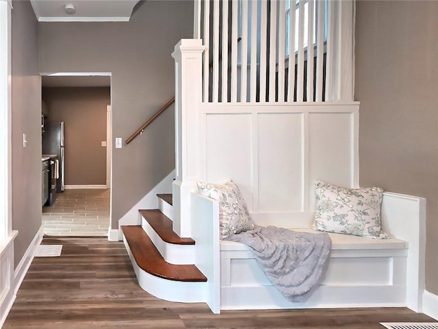 interior space with wood-type flooring and ornamental molding