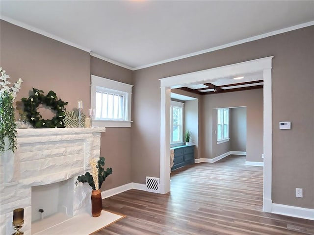 interior space with hardwood / wood-style flooring, crown molding, and a healthy amount of sunlight