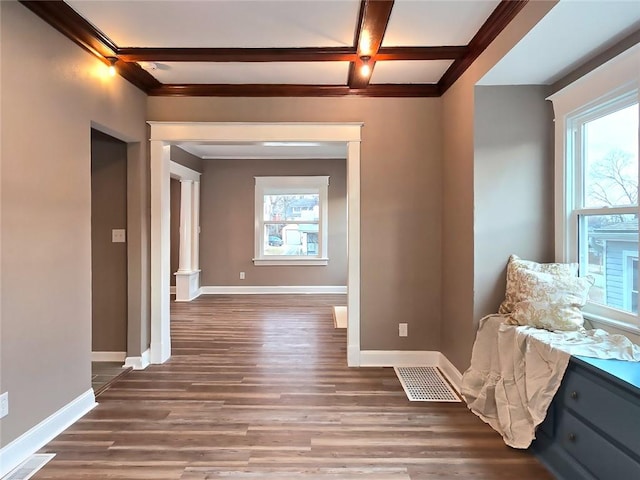 interior space with beam ceiling, dark hardwood / wood-style flooring, and coffered ceiling