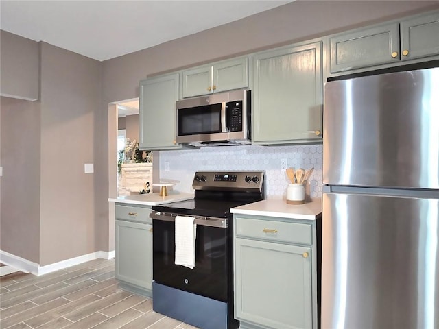 kitchen featuring decorative backsplash, light hardwood / wood-style flooring, and stainless steel appliances