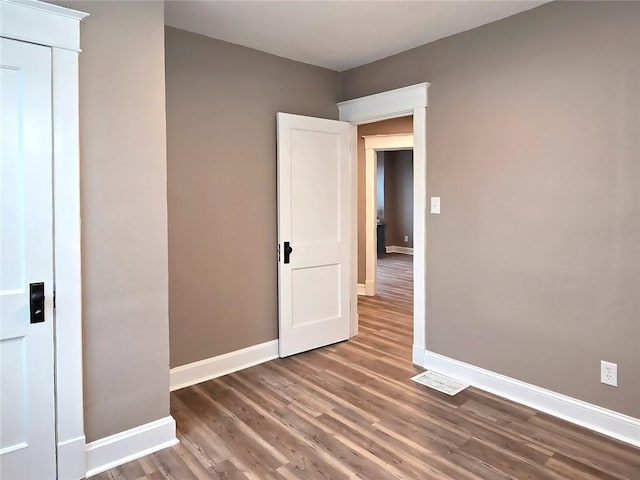 unfurnished bedroom with hardwood / wood-style flooring