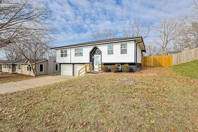 bi-level home featuring a front lawn and a garage