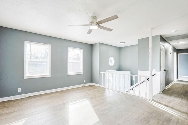 spare room featuring ceiling fan and hardwood / wood-style floors