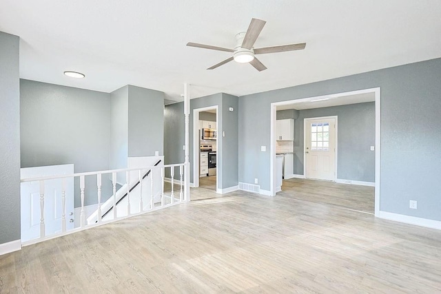 spare room featuring light hardwood / wood-style floors and ceiling fan