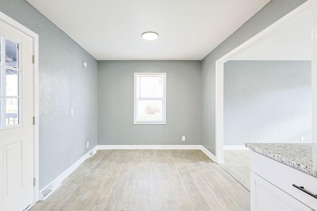 unfurnished dining area featuring light hardwood / wood-style floors