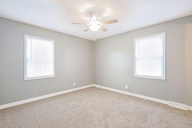 spare room with carpet, plenty of natural light, and ceiling fan