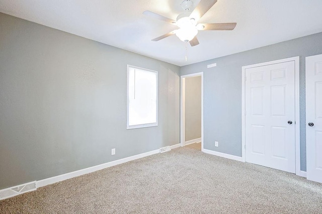 unfurnished bedroom featuring ceiling fan and carpet floors