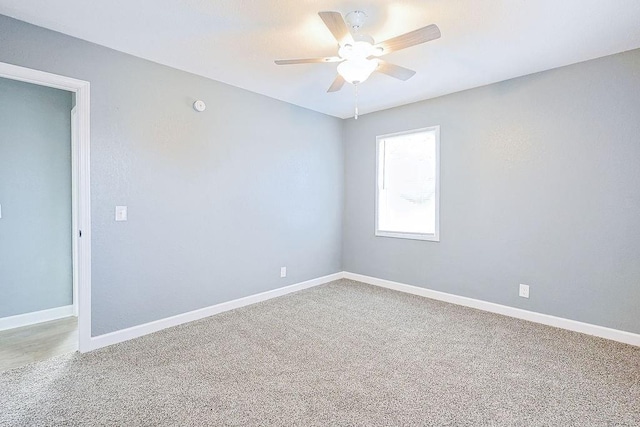 empty room featuring carpet flooring and ceiling fan