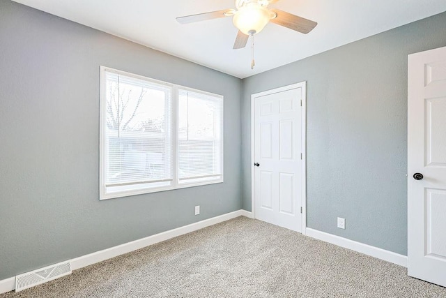 unfurnished bedroom with ceiling fan and carpet