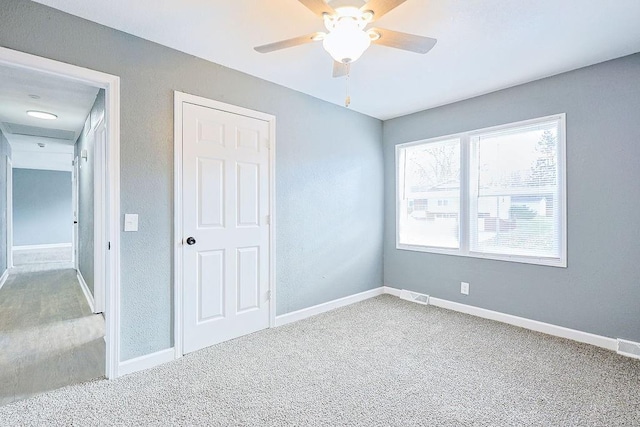 unfurnished bedroom featuring ceiling fan and carpet floors