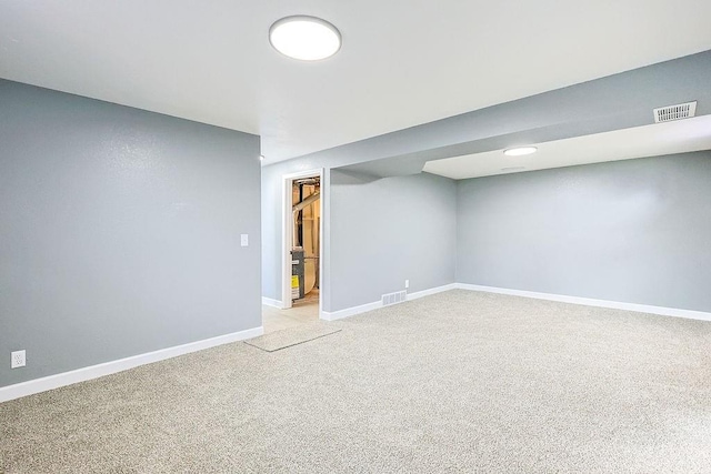 basement featuring light colored carpet