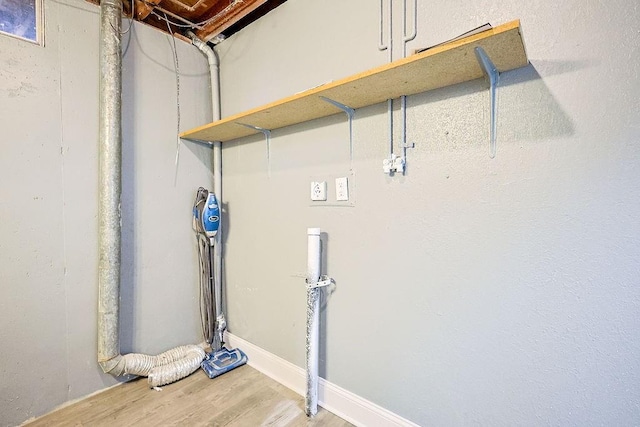 clothes washing area with hardwood / wood-style floors