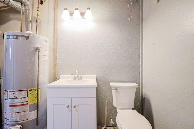 bathroom with water heater, vanity, and toilet