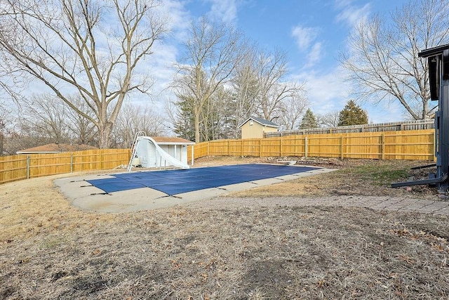 view of pool with a patio and a water slide