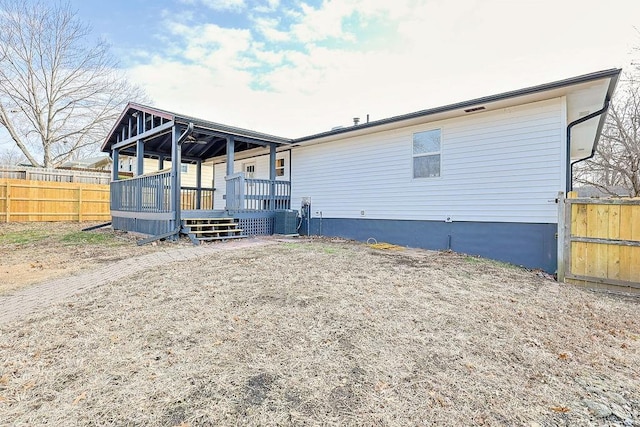 view of front of property with a deck and central AC unit