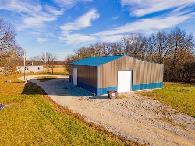 view of outdoor structure with a yard and a garage