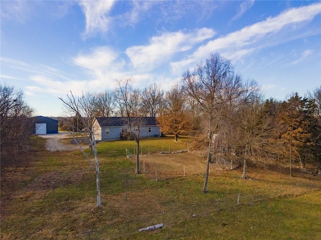 view of yard featuring a rural view and a garage