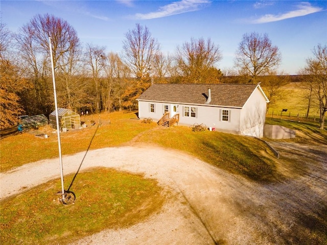 view of front of house featuring a front yard and an outdoor structure