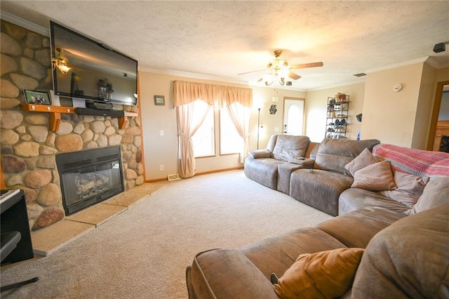 carpeted living room featuring a fireplace, a textured ceiling, ceiling fan, and crown molding