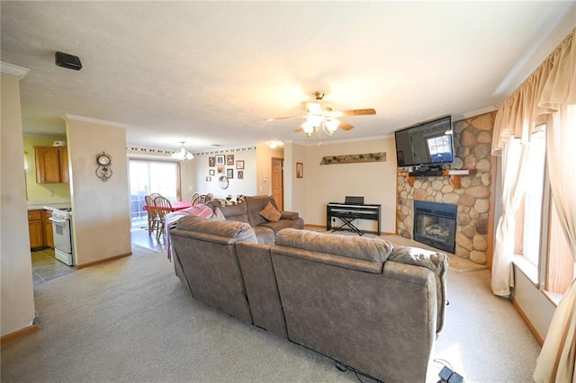 living room featuring light colored carpet, a stone fireplace, ceiling fan, and ornamental molding