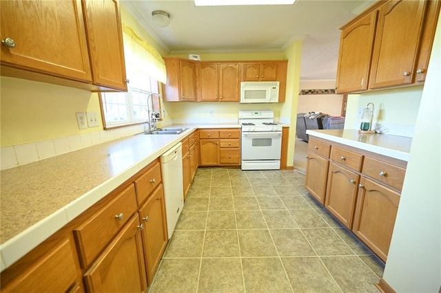 kitchen featuring crown molding, white appliances, sink, and light tile patterned floors