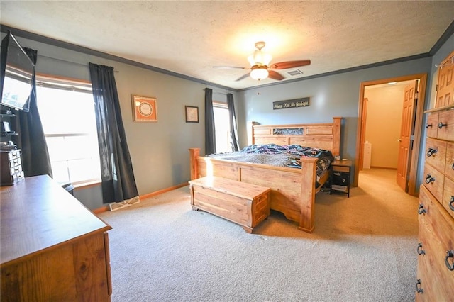 carpeted bedroom featuring a textured ceiling, ceiling fan, crown molding, and multiple windows