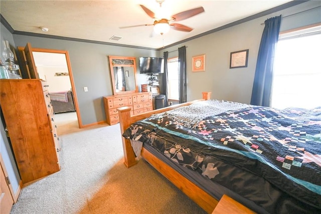 bedroom with ceiling fan, ornamental molding, and carpet floors