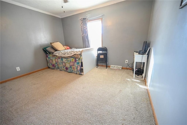 carpeted bedroom with ceiling fan and ornamental molding