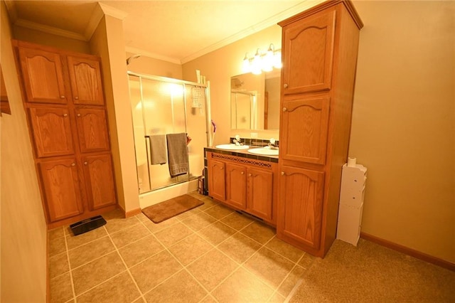 bathroom with a shower with door, vanity, and ornamental molding