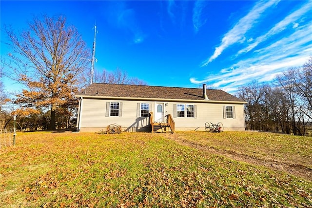 rear view of property with a lawn