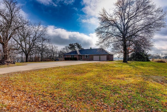 view of front of house with a front yard and a garage