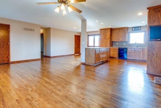 kitchen with decorative backsplash, light hardwood / wood-style flooring, ceiling fan, and plenty of natural light