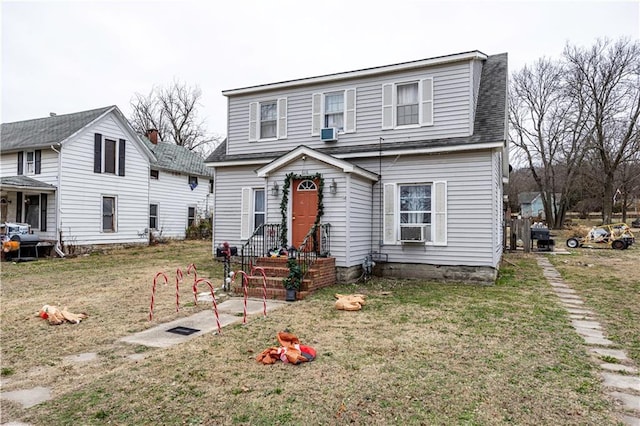 view of front property featuring cooling unit and a front yard