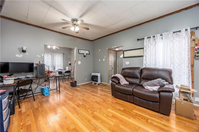 living room with ceiling fan, crown molding, light hardwood / wood-style flooring, and heating unit