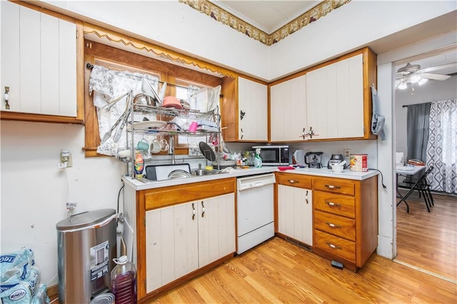 kitchen with light wood-type flooring, white cabinets, ceiling fan, sink, and dishwasher