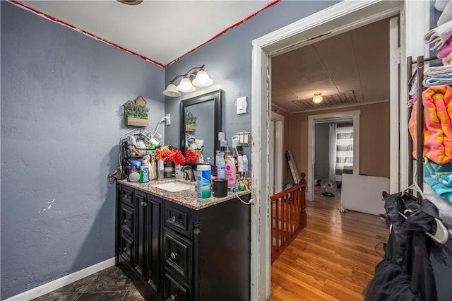 bathroom with vanity and hardwood / wood-style flooring