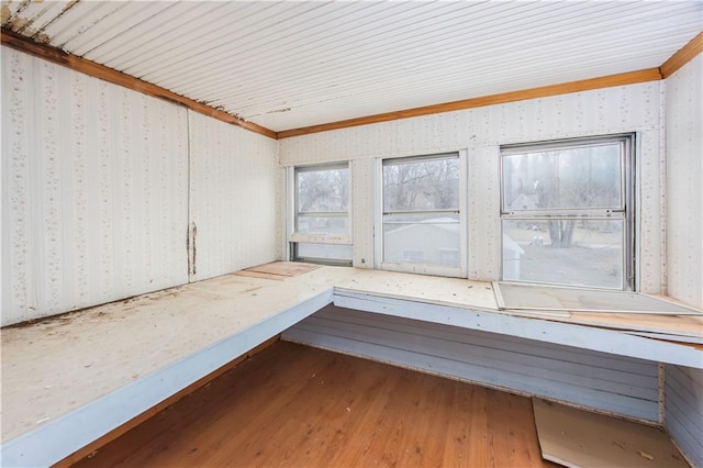 interior space with wood-type flooring and crown molding