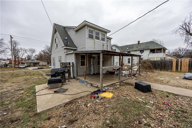 back of house with a deck